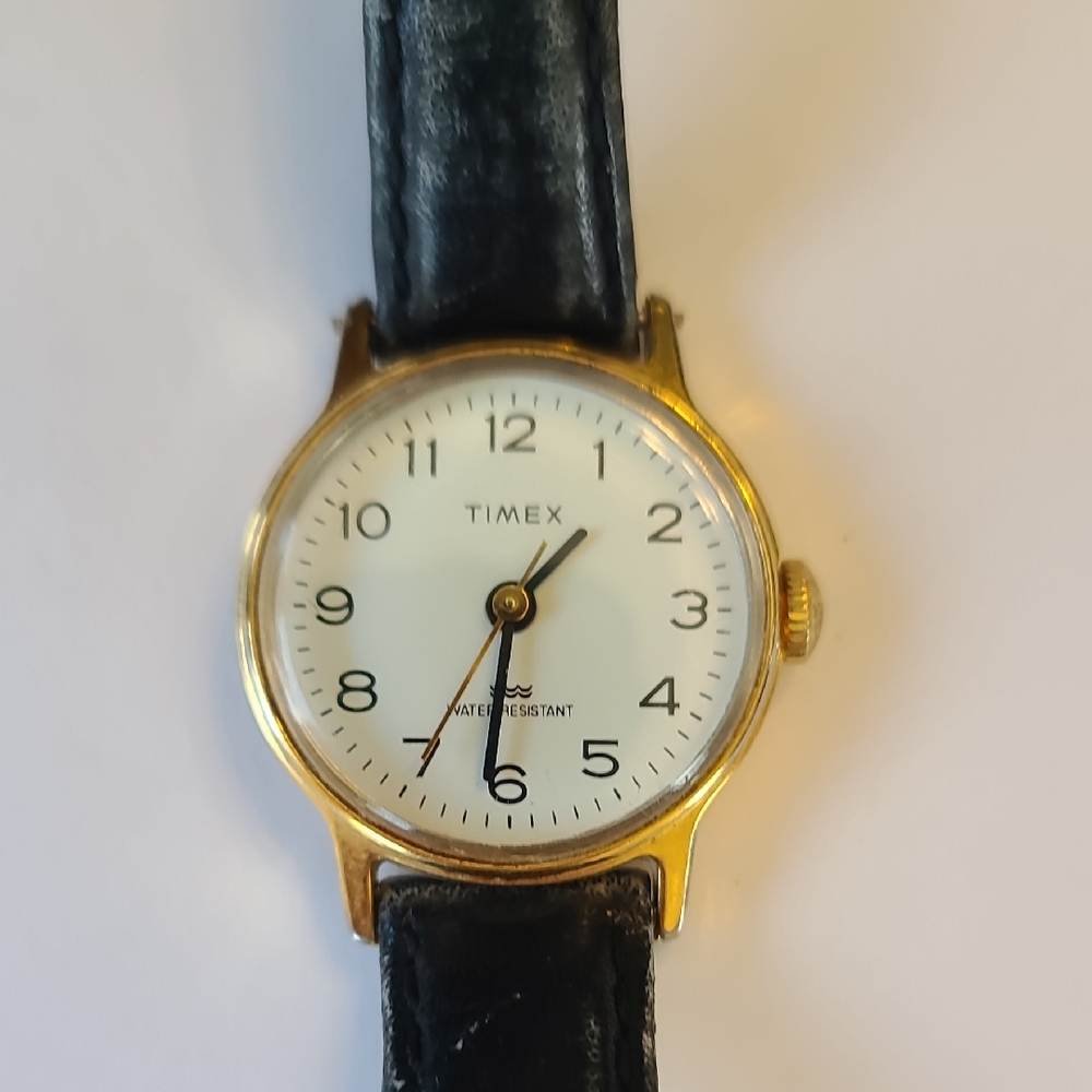 Vintage Timex Gold Case Watch with White Dial and Black Leather Strap